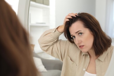 Photo of Woman with hair loss problem at home