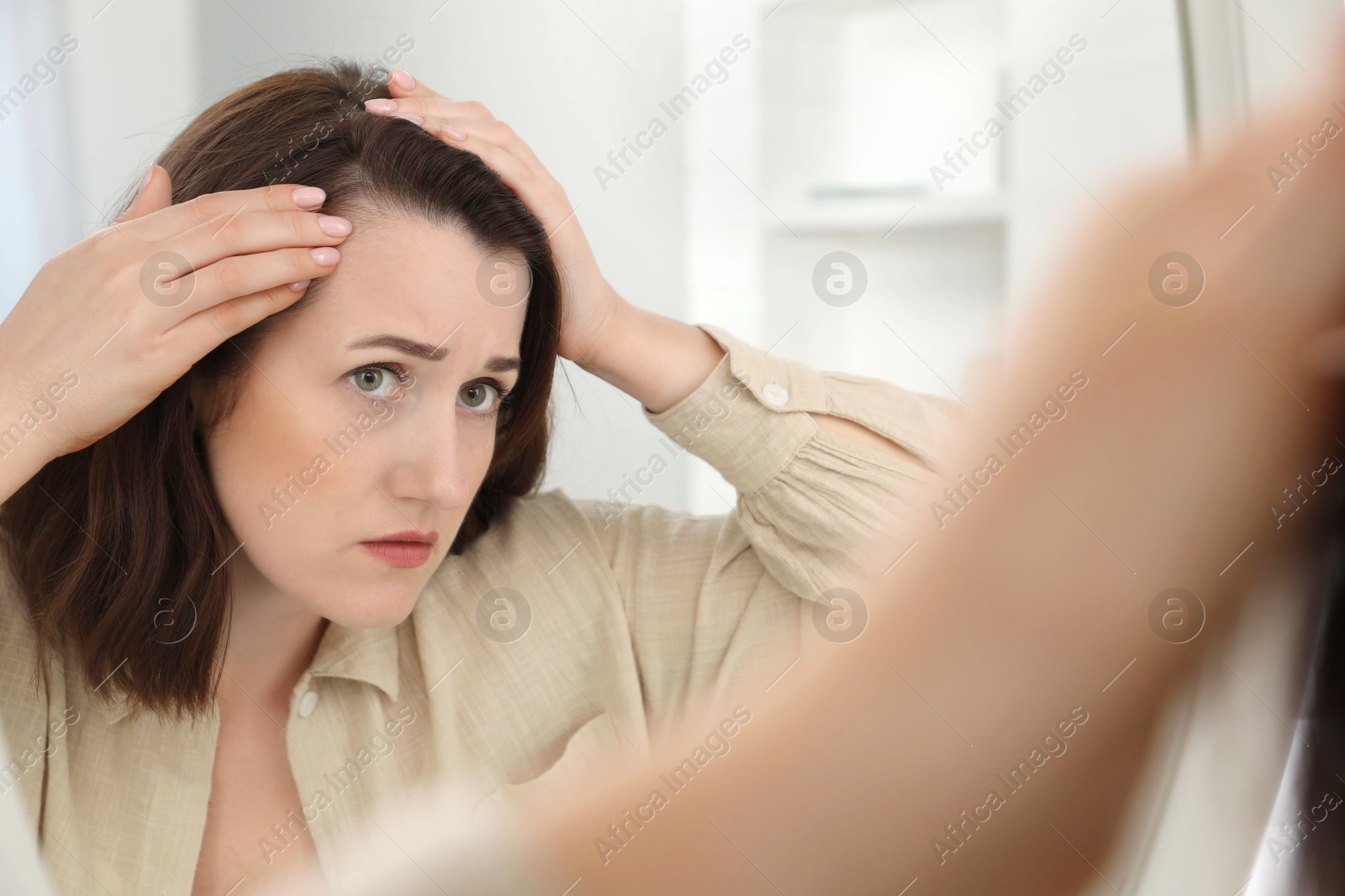 Photo of Woman with hair loss problem at home