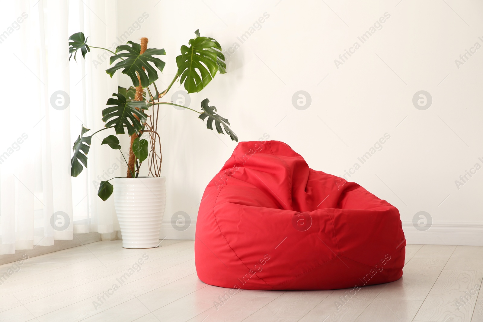 Photo of Red bean bag chair on floor in room