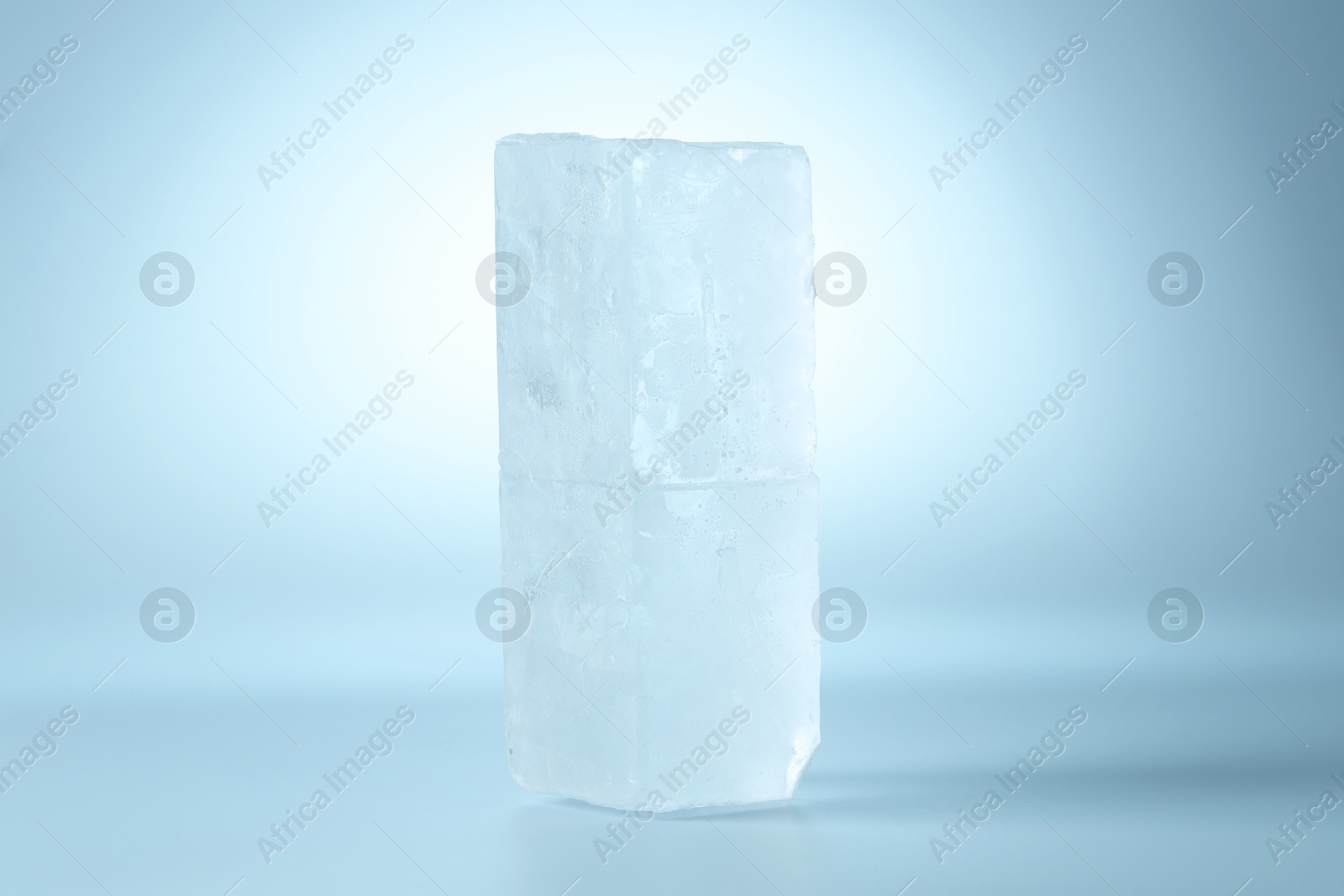 Photo of Blocks of clear ice on light blue background