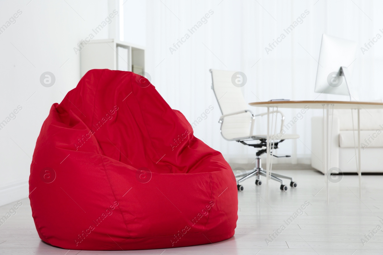 Photo of Red bean bag chair on floor in office