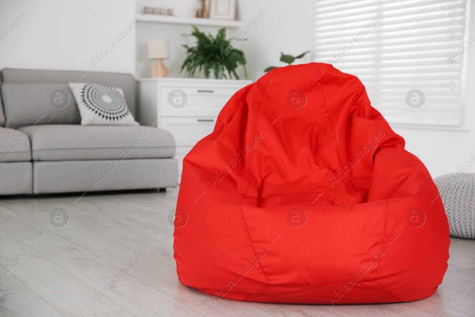 Photo of Red bean bag chair on floor in room