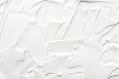 Photo of Texture of face care cream as background, top view