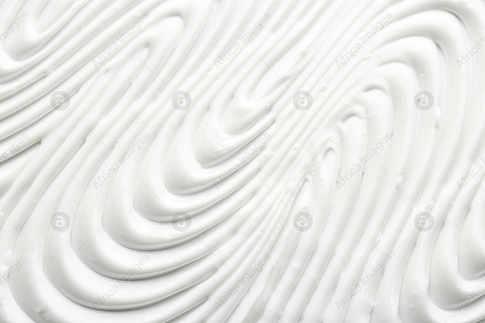 Photo of Texture of face care cream as background, top view