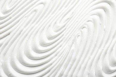 Photo of Texture of face care cream as background, top view