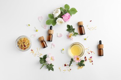 Photo of Aromatherapy. Essential oils, flowers and petals on white background, flat lay