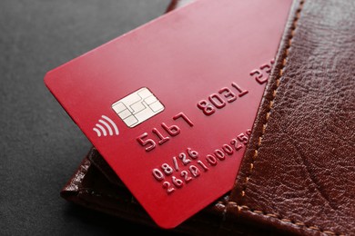 Credit card in leather wallet on black background, closeup