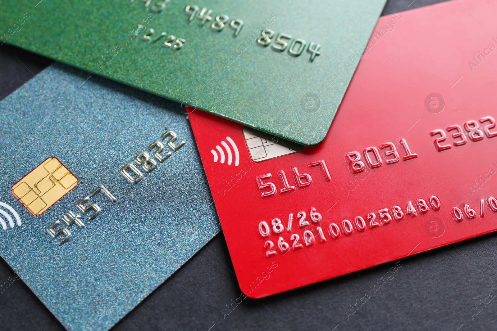 Photo of Different credit cards on black background, closeup