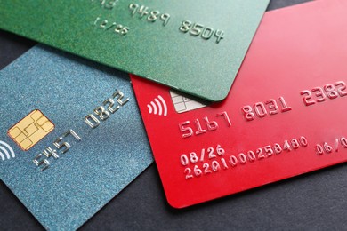 Photo of Different credit cards on black background, closeup