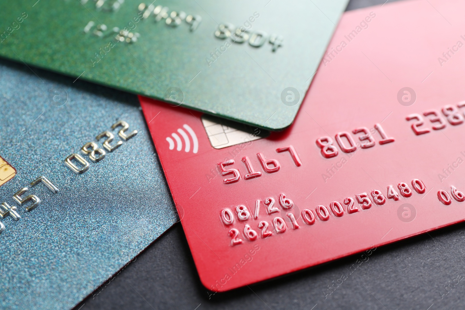 Photo of Different credit cards on black background, closeup