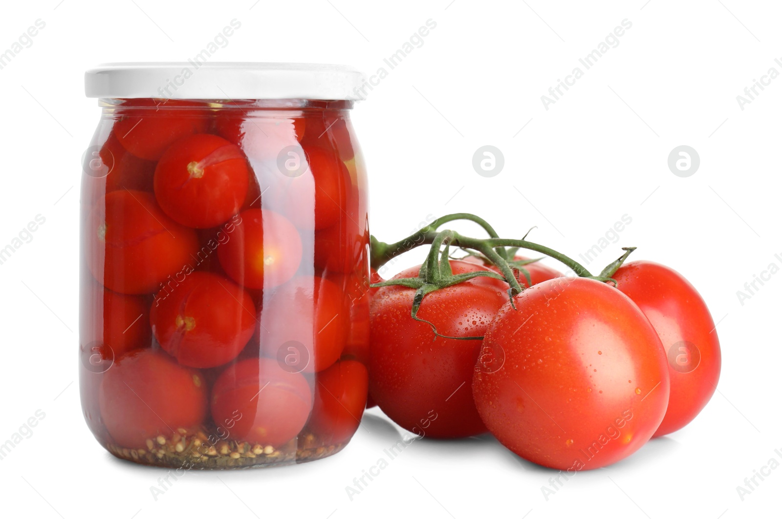 Photo of Tasty pickled tomatoes in jar and vegetable isolated on white