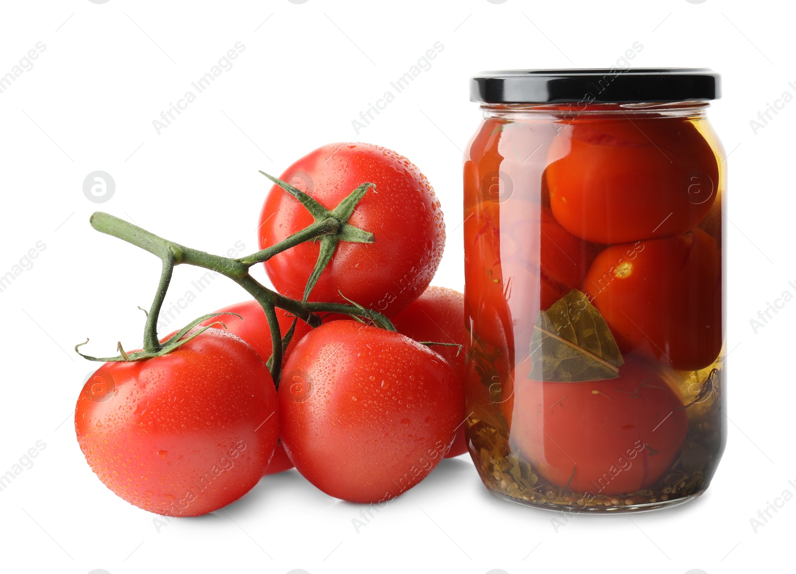 Photo of Tasty pickled tomatoes in jar and vegetable isolated on white