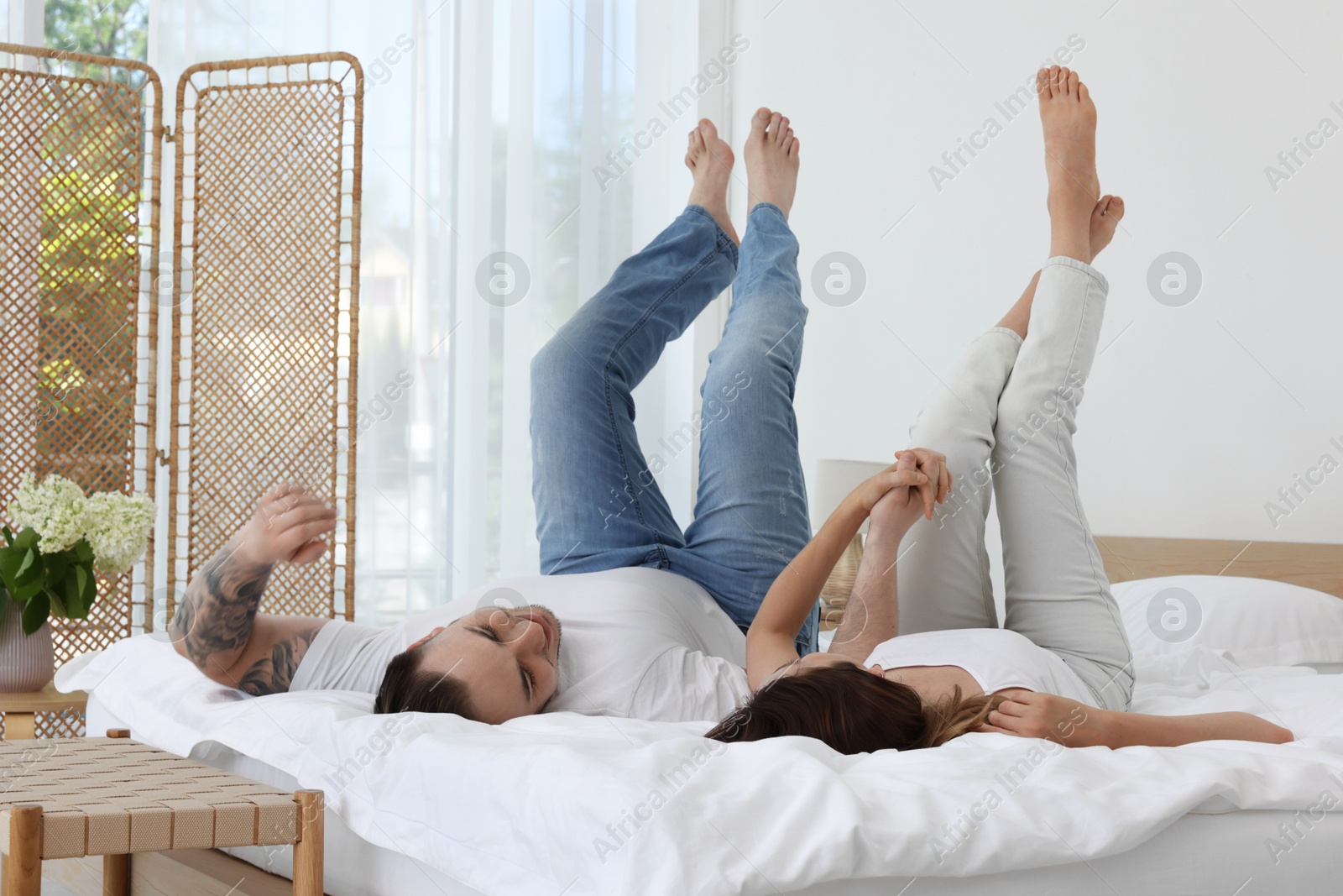 Photo of Lovely couple spending time together on bed at home