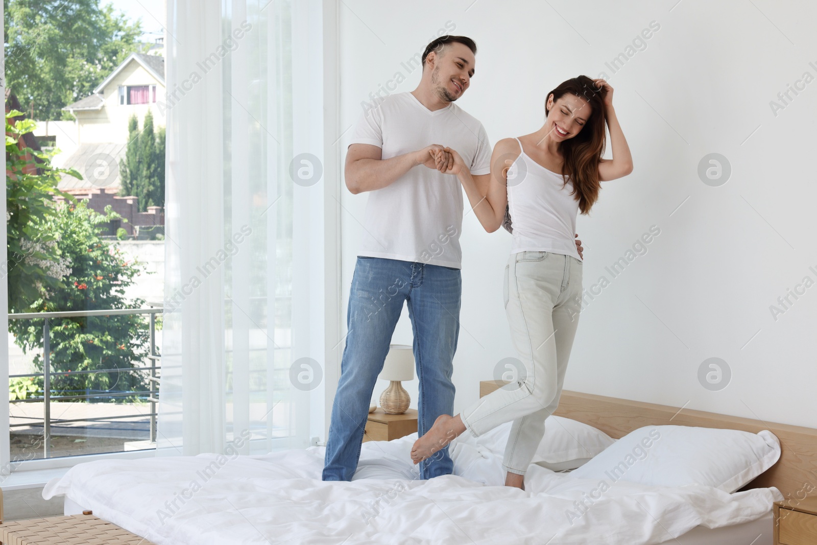 Photo of Lovely couple spending time together on bed at home