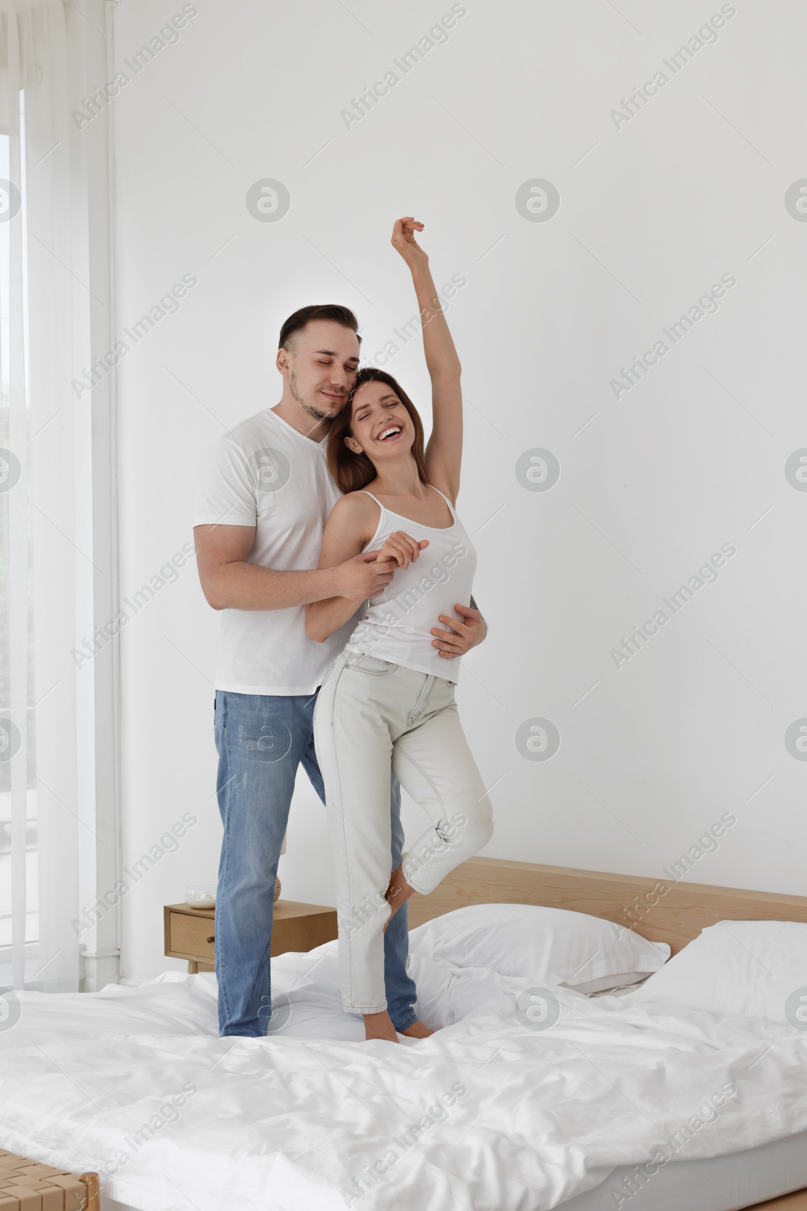 Photo of Lovely couple spending time together on bed at home