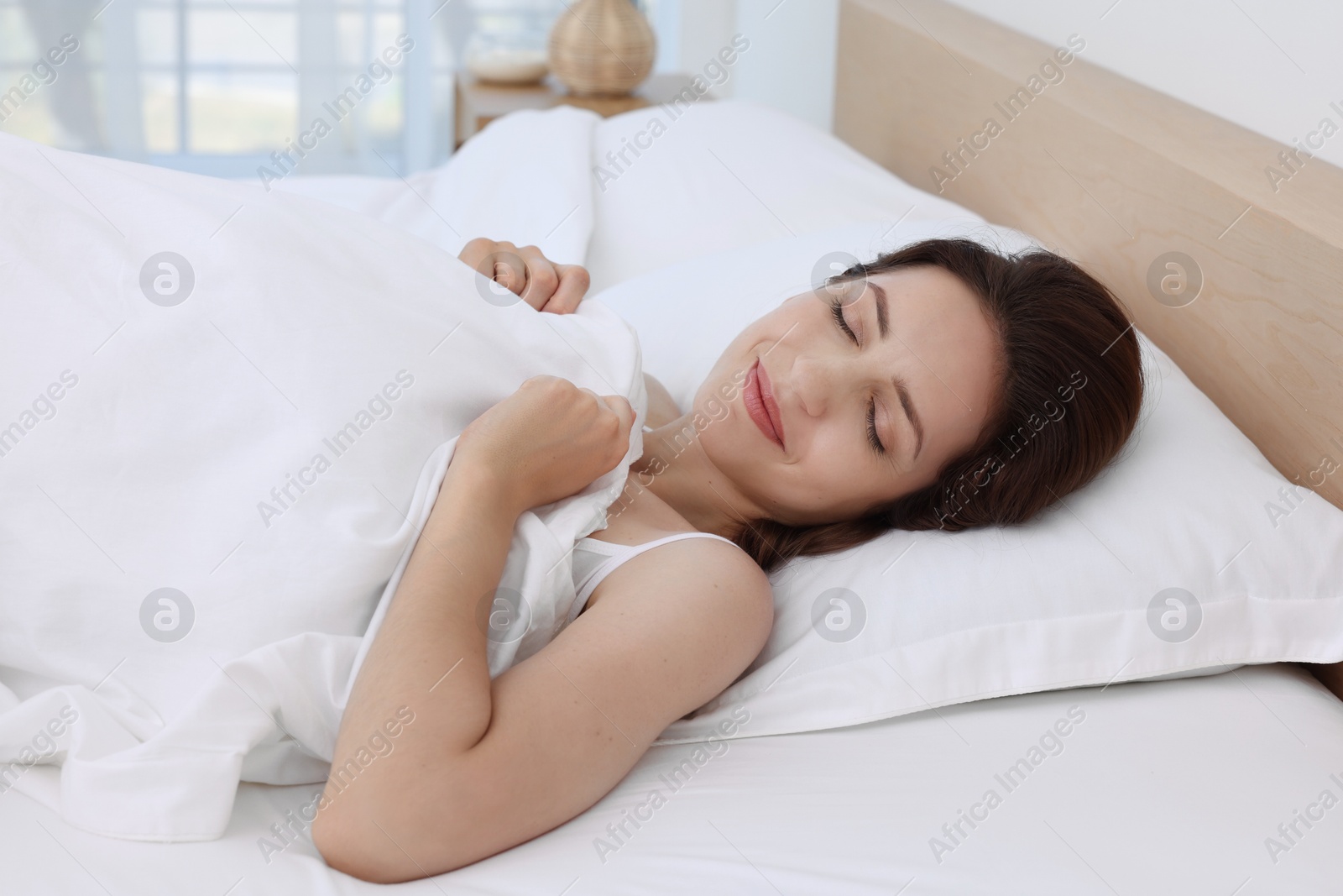 Photo of Bedtime. Woman sleeping in bed at home