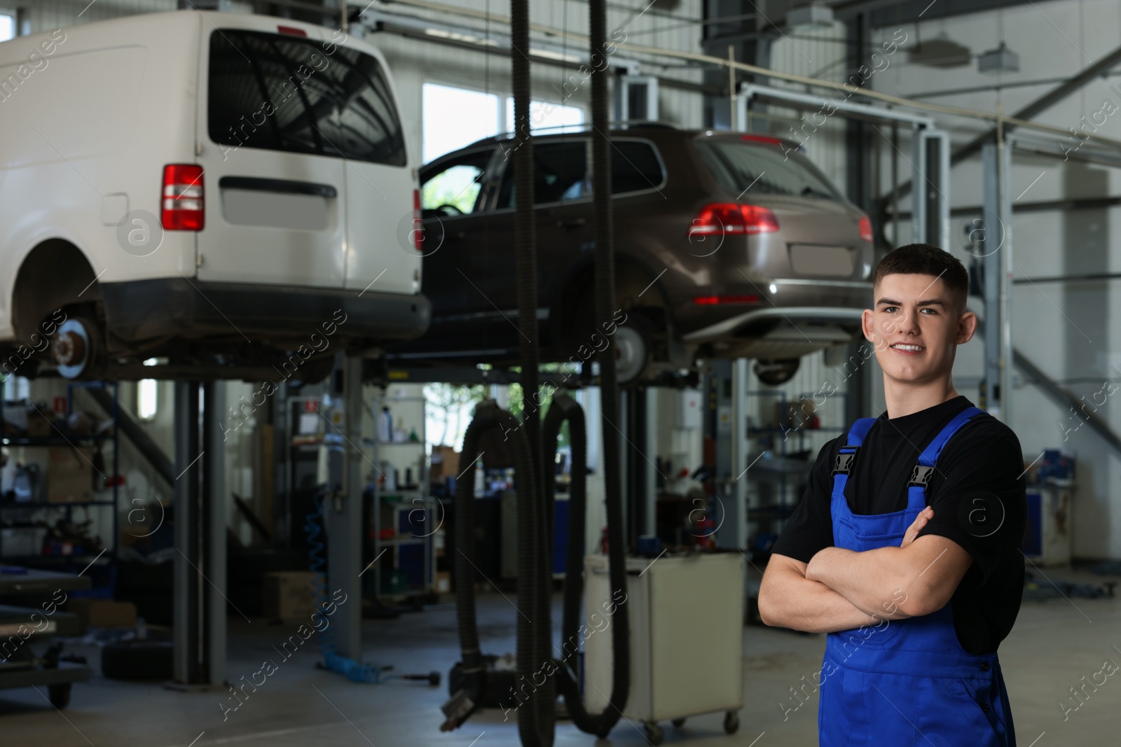 Photo of Young auto mechanic at automobile repair shop