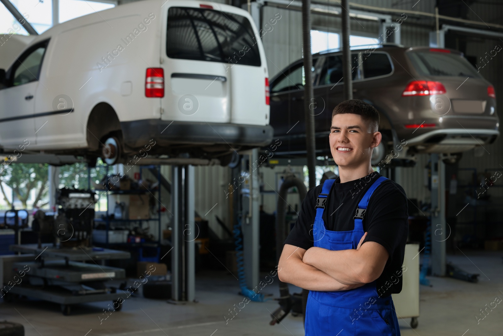 Photo of Young auto mechanic at automobile repair shop