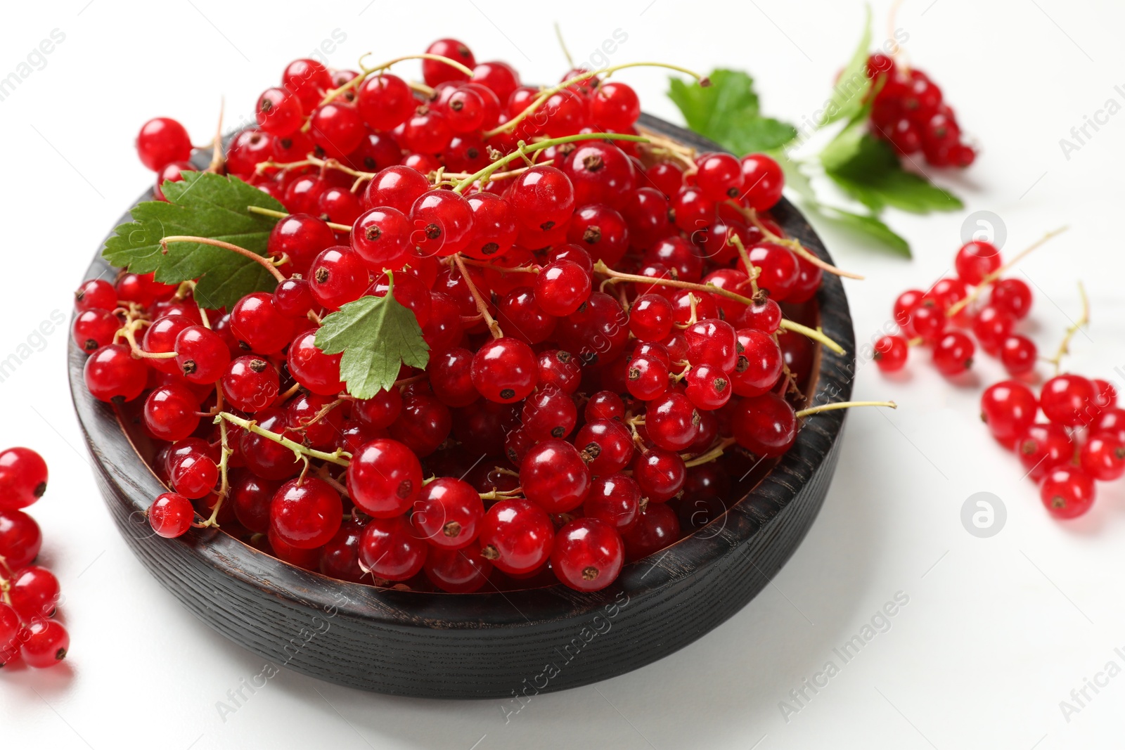 Photo of Fresh red currant berries on white table, closeup