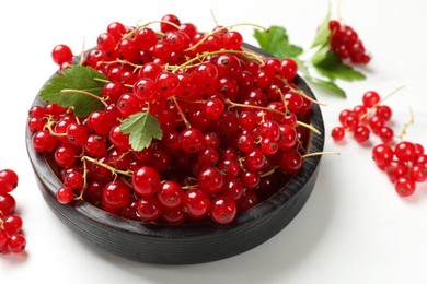 Photo of Fresh red currant berries on white table, closeup