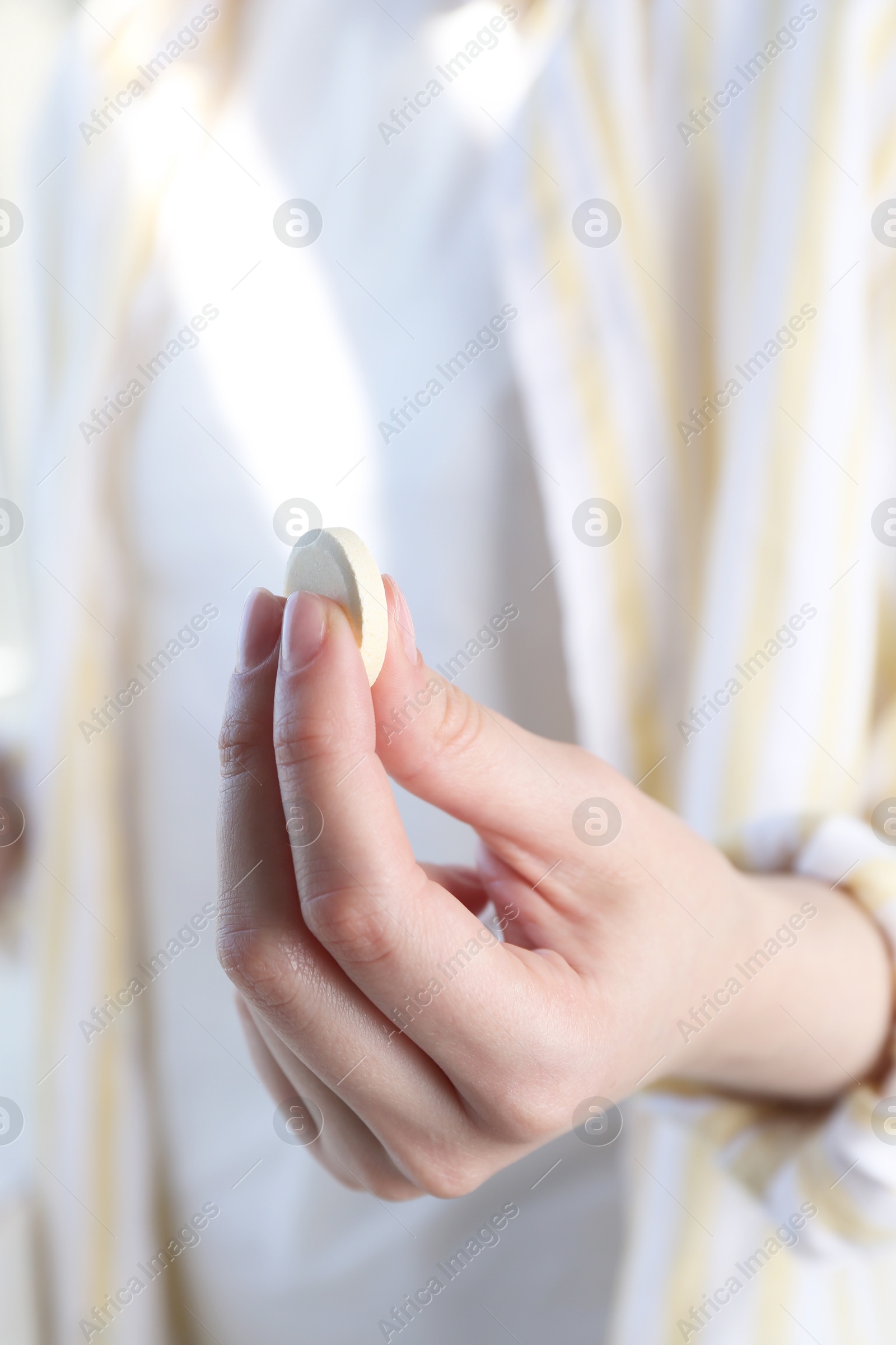 Photo of Woman holding one effervescent in hand, closeup