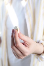 Woman holding one effervescent in hand, closeup