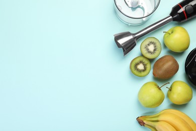 Photo of Hand blender kit and fresh fruits on light blue background, flat lay. Space for text