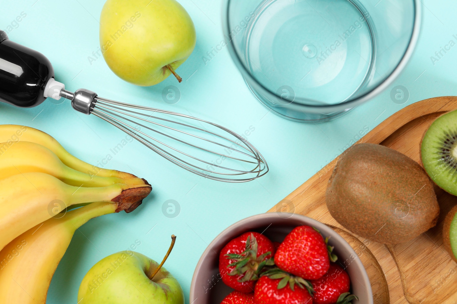 Photo of Hand blender kit and fresh fruits on light blue background, flat lay