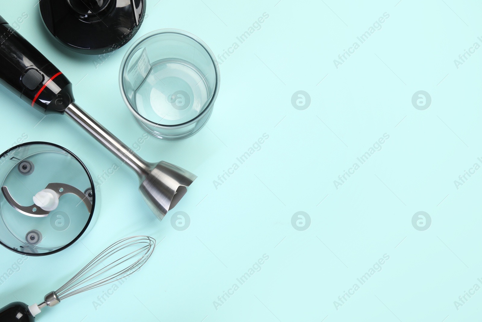 Photo of Hand blender kit on light blue background, flat lay. Space for text