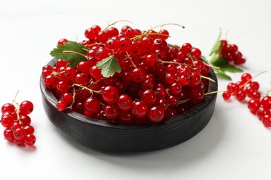 Photo of Fresh red currant berries on white table, closeup