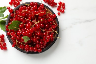 Photo of Fresh red currant berries on white table, top view. Space for text