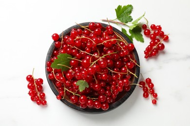 Photo of Fresh red currant berries on white table, top view