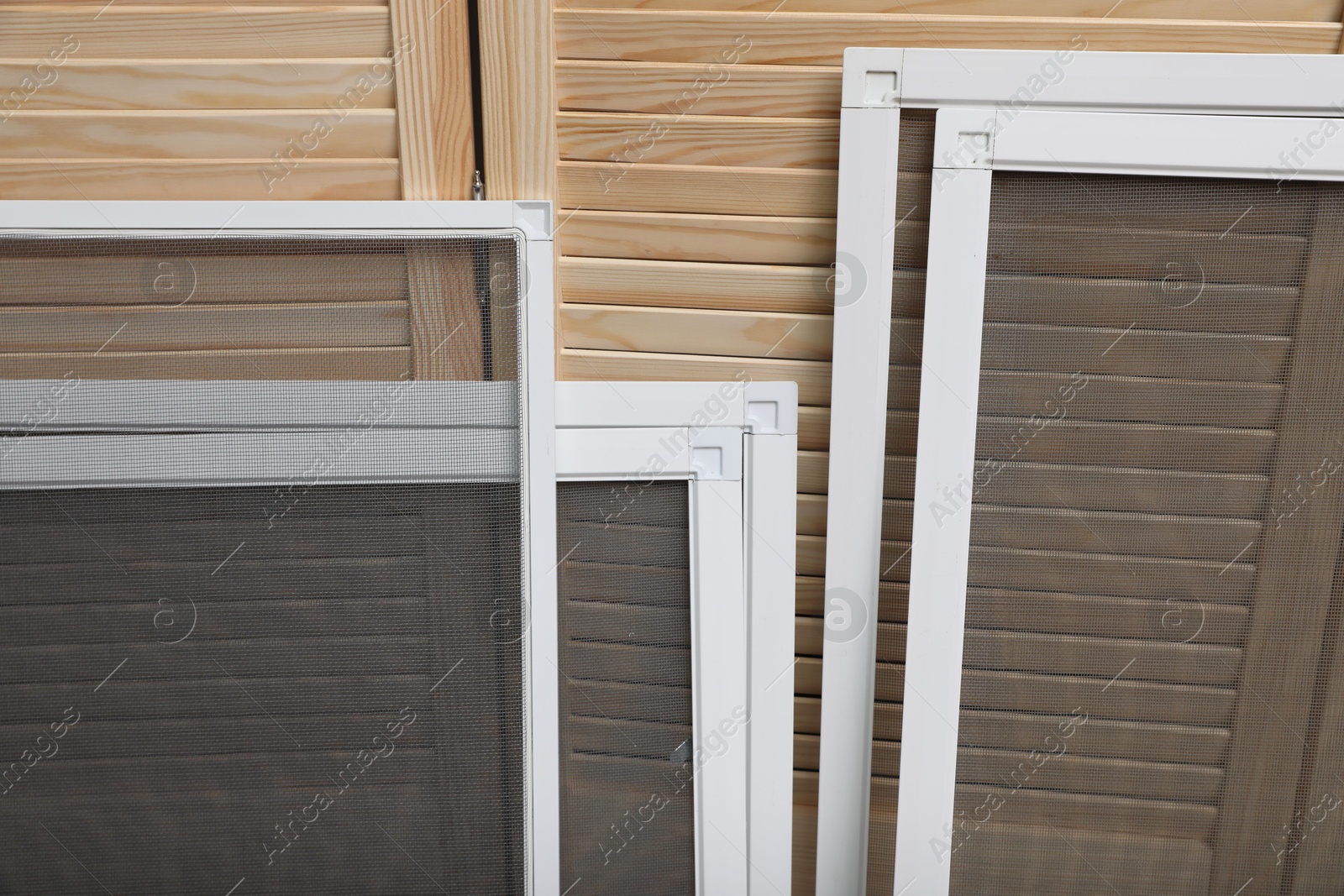 Photo of Set of window screens near wooden folding screen