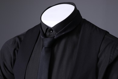 Photo of Male mannequin dressed in stylish black suit on grey background, closeup