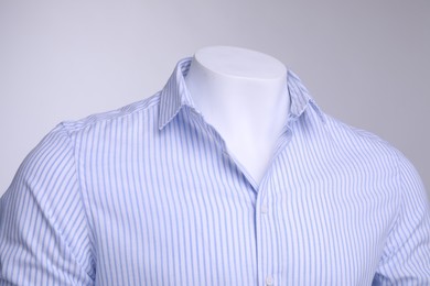 Photo of Male mannequin dressed in stylish shirt on grey background, closeup