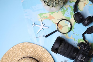 Photo of Flat lay composition with travel blogger`s items on light blue background