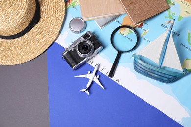 Travel blogger. Flat lay composition with vintage camera and magnifying glass on color background