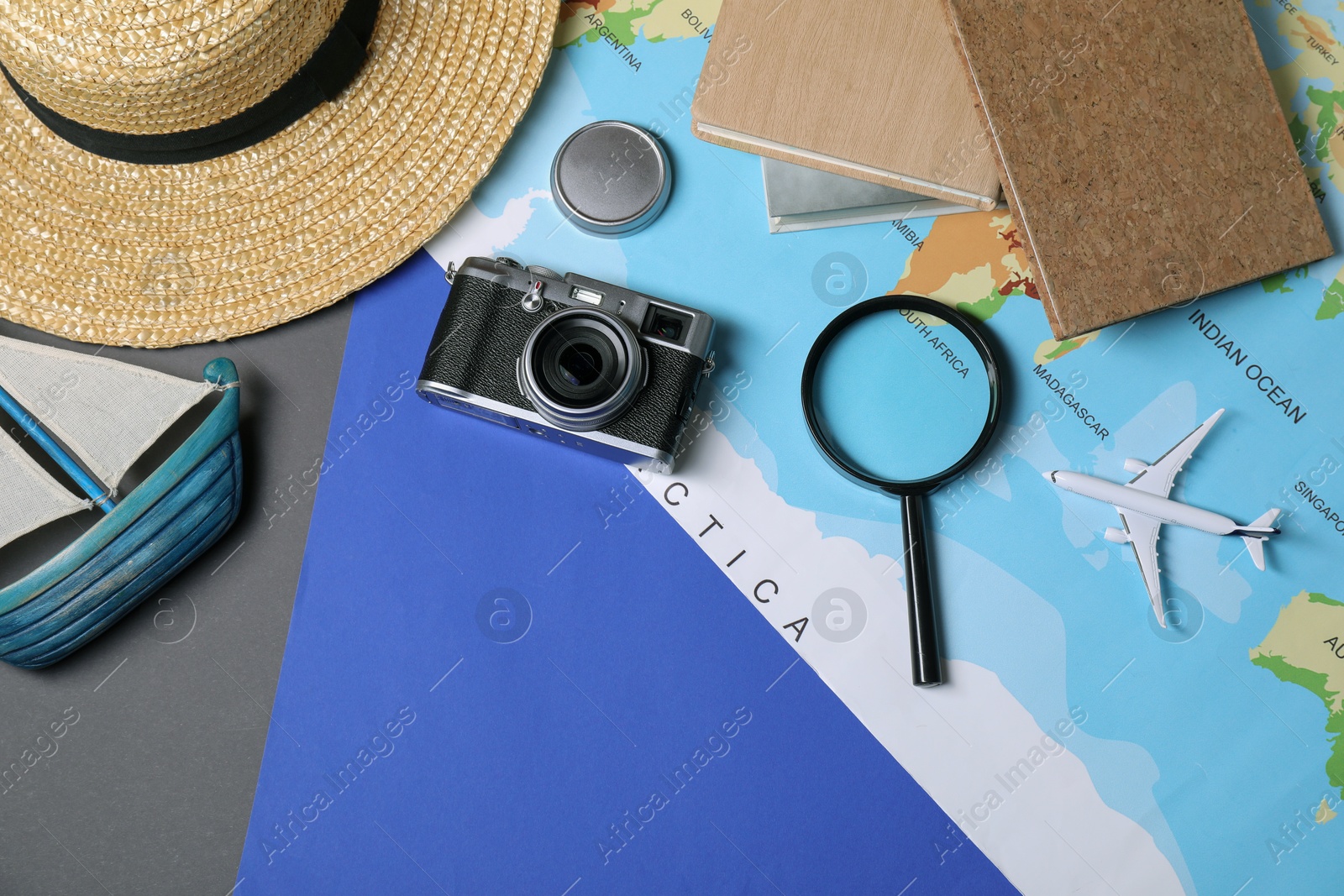 Photo of Travel blogger. Flat lay composition with vintage camera and magnifying glass on color background