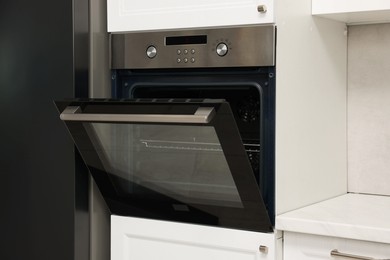 Open electric oven in kitchen. Cooking appliance