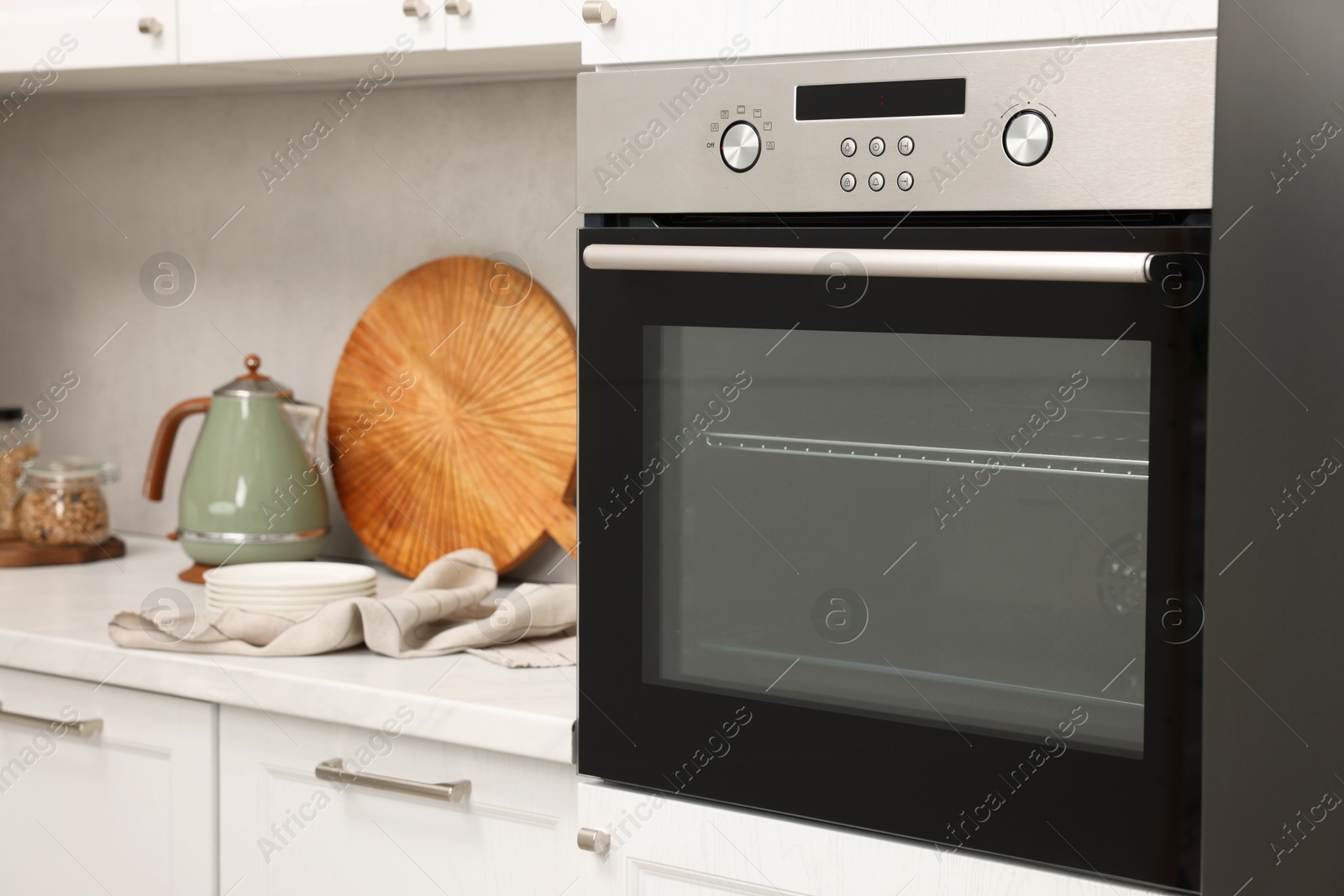 Photo of New electric oven in kitchen. Cooking appliance