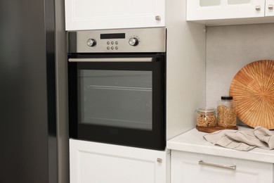 Photo of New electric oven in kitchen. Cooking appliance