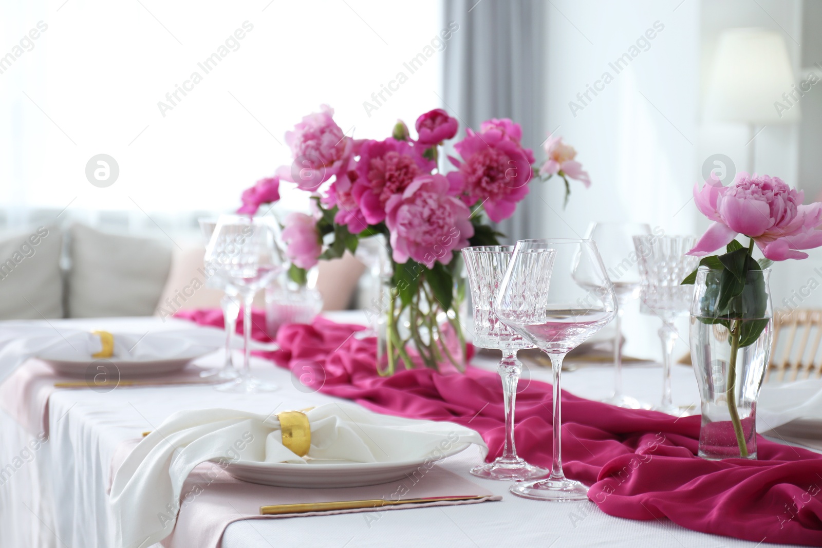 Photo of Beautiful table setting with pink peonies in dining room