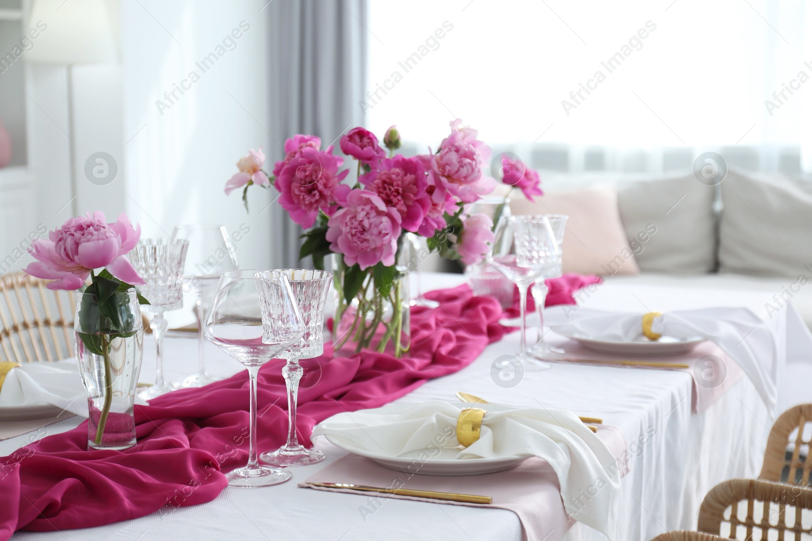 Photo of Beautiful table setting with pink peonies in dining room