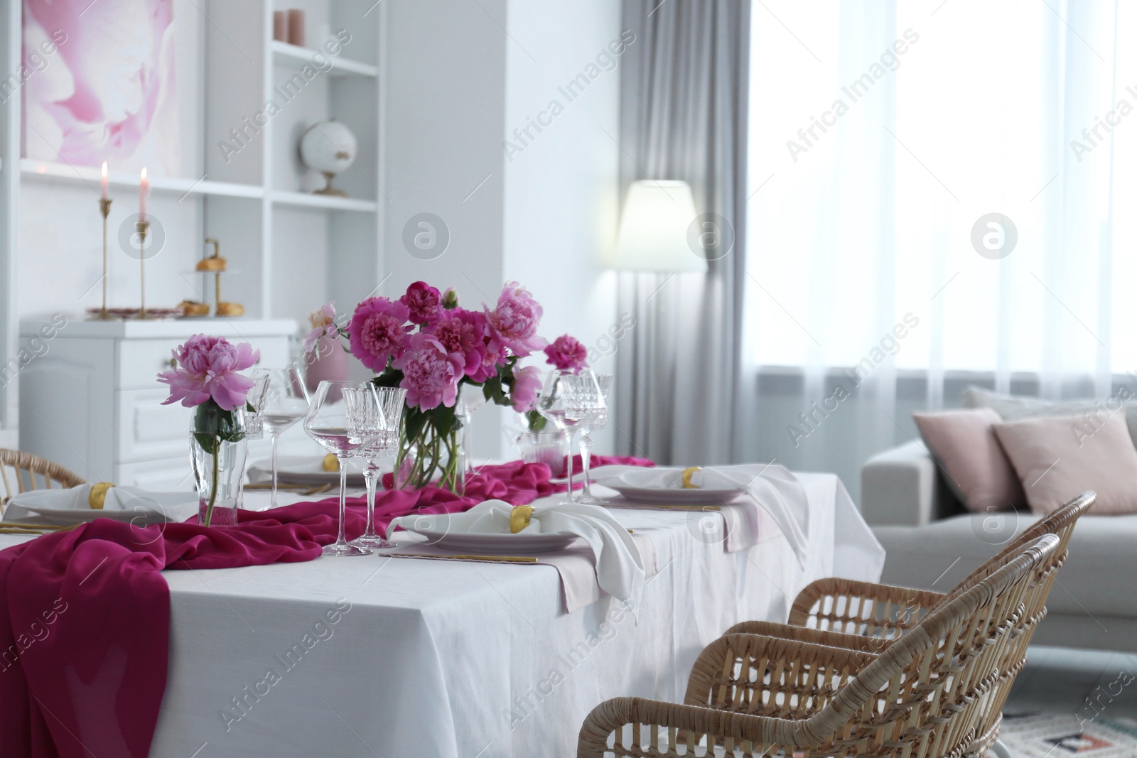 Photo of Beautiful table setting with pink peonies in dining room