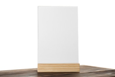 Photo of Menu holder on wooden table against white background. Mockup for design