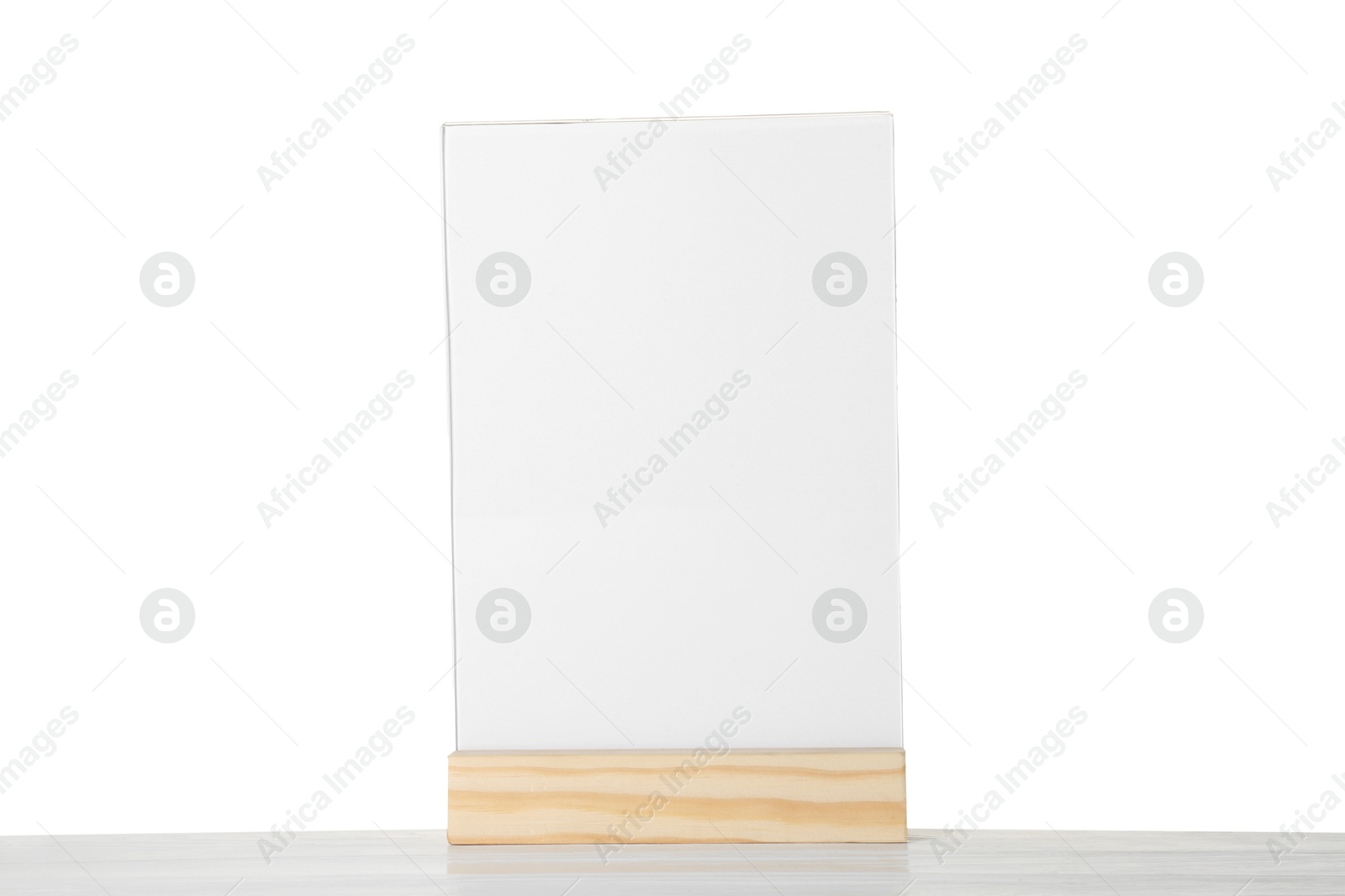 Photo of Menu holder on wooden table against white background. Mockup for design