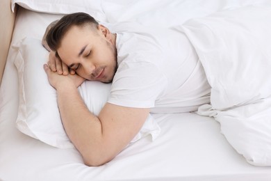 Bedtime. Handsome man sleeping in bed indoors