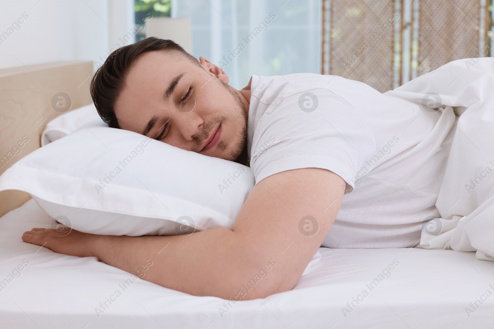 Photo of Bedtime. Handsome man sleeping in bed indoors