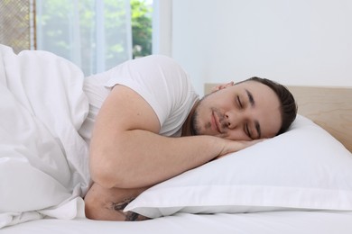 Bedtime. Handsome man sleeping in bed indoors