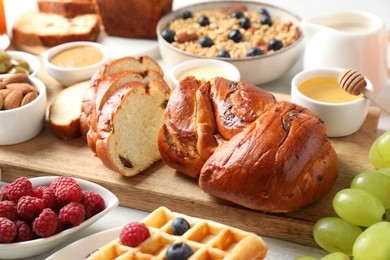 Different meals served for breakfast on white table